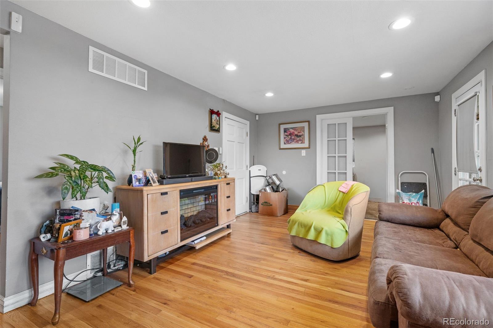 4956 Umatilla Street Denver, CO 80221 - Photo 9 of 33 a living room with furniture and a flat screen tv