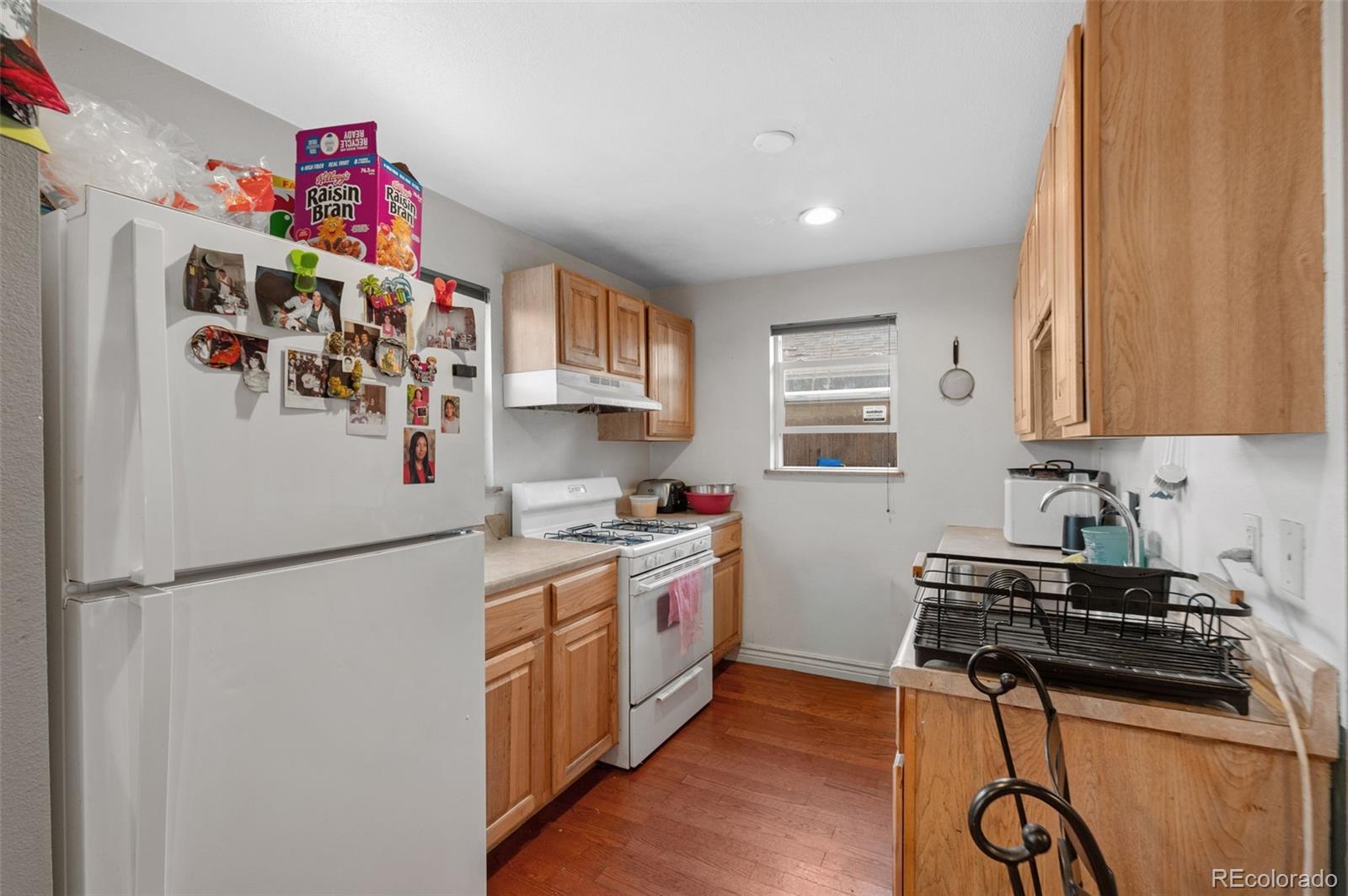 4956 Umatilla Street Denver, CO 80221 - Photo 10 of 33 a kitchen with stainless steel appliances granite countertop a refrigerator and a sink