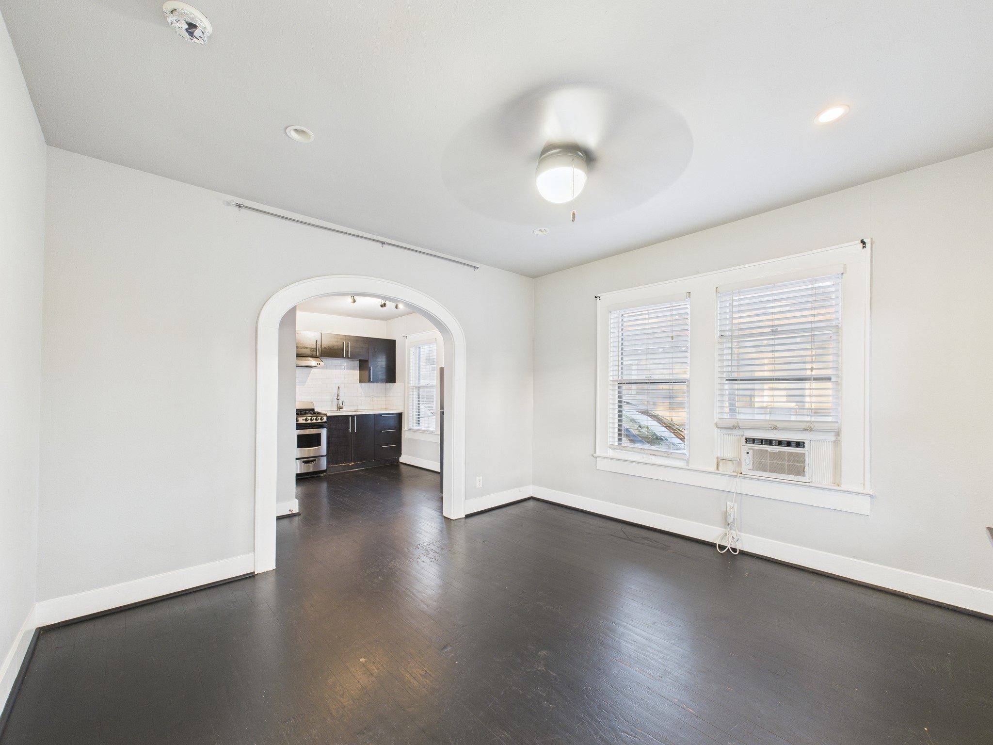 605 Enid Street, Unit 1 Houston, TX 77009 - Photo 1 of 9 an empty room with wooden floor and a large window