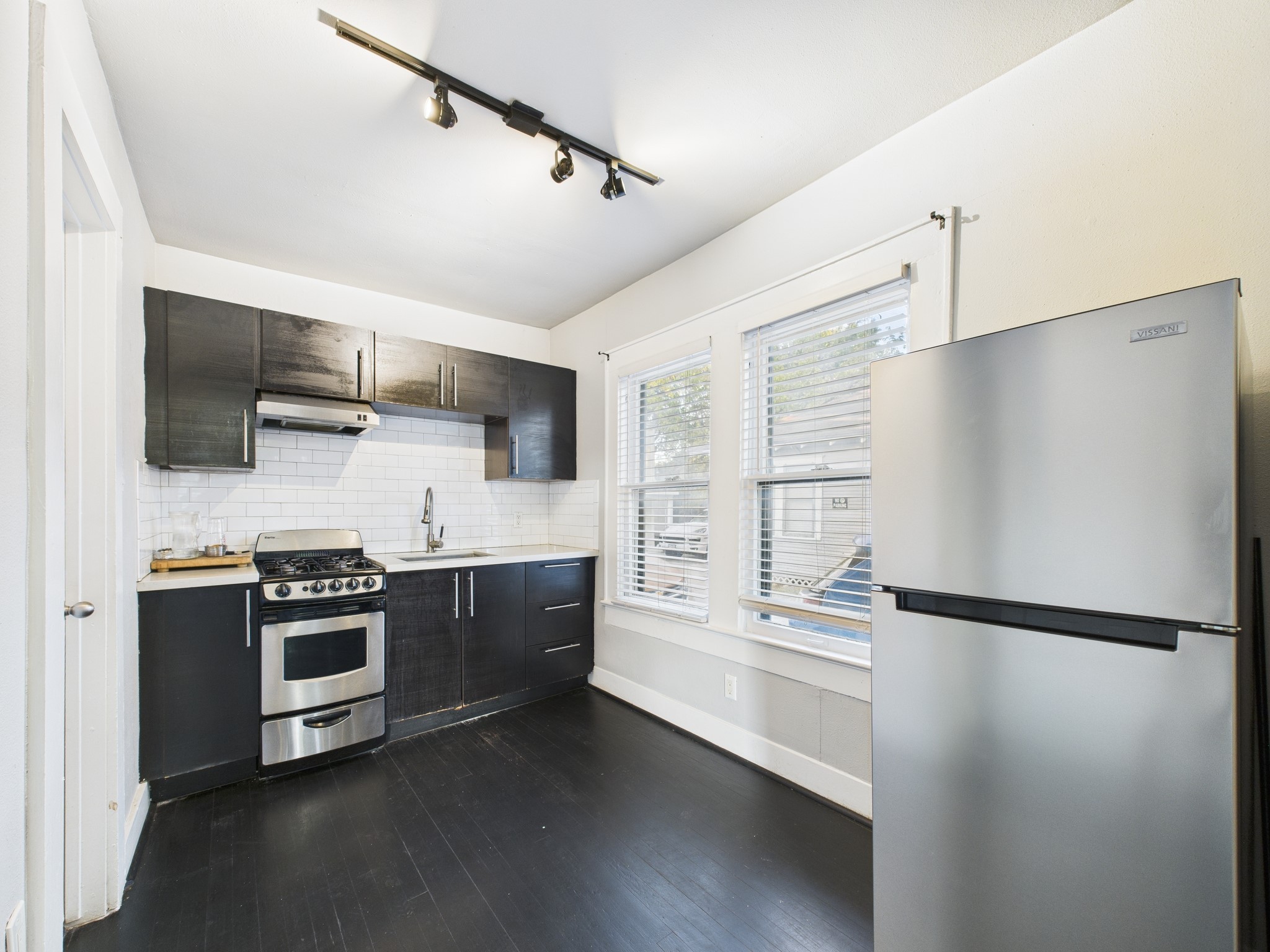 605 Enid Street, Unit 1 Houston, TX 77009 - Photo 3 of 9 a kitchen with stainless steel appliances a refrigerator sink and microwave