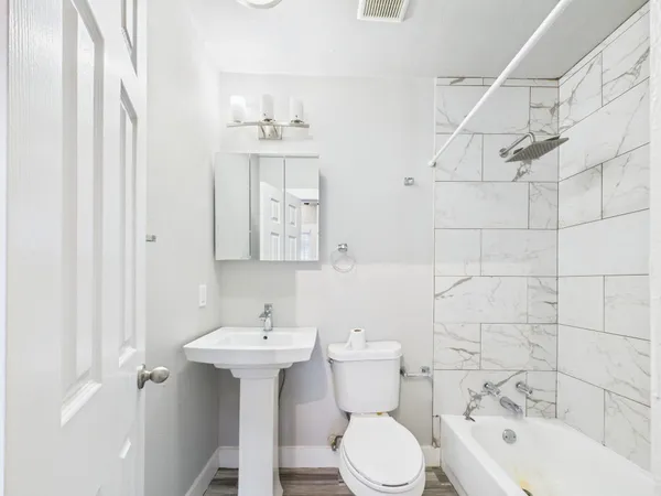 a bathroom with a sink toilet and shower