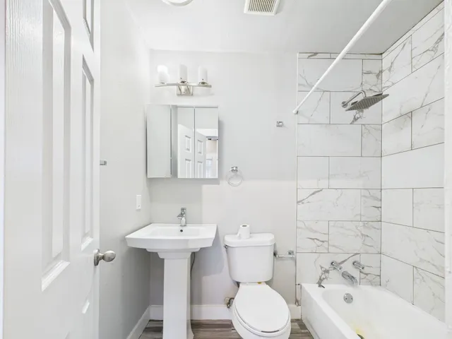 a bathroom with a sink toilet and shower