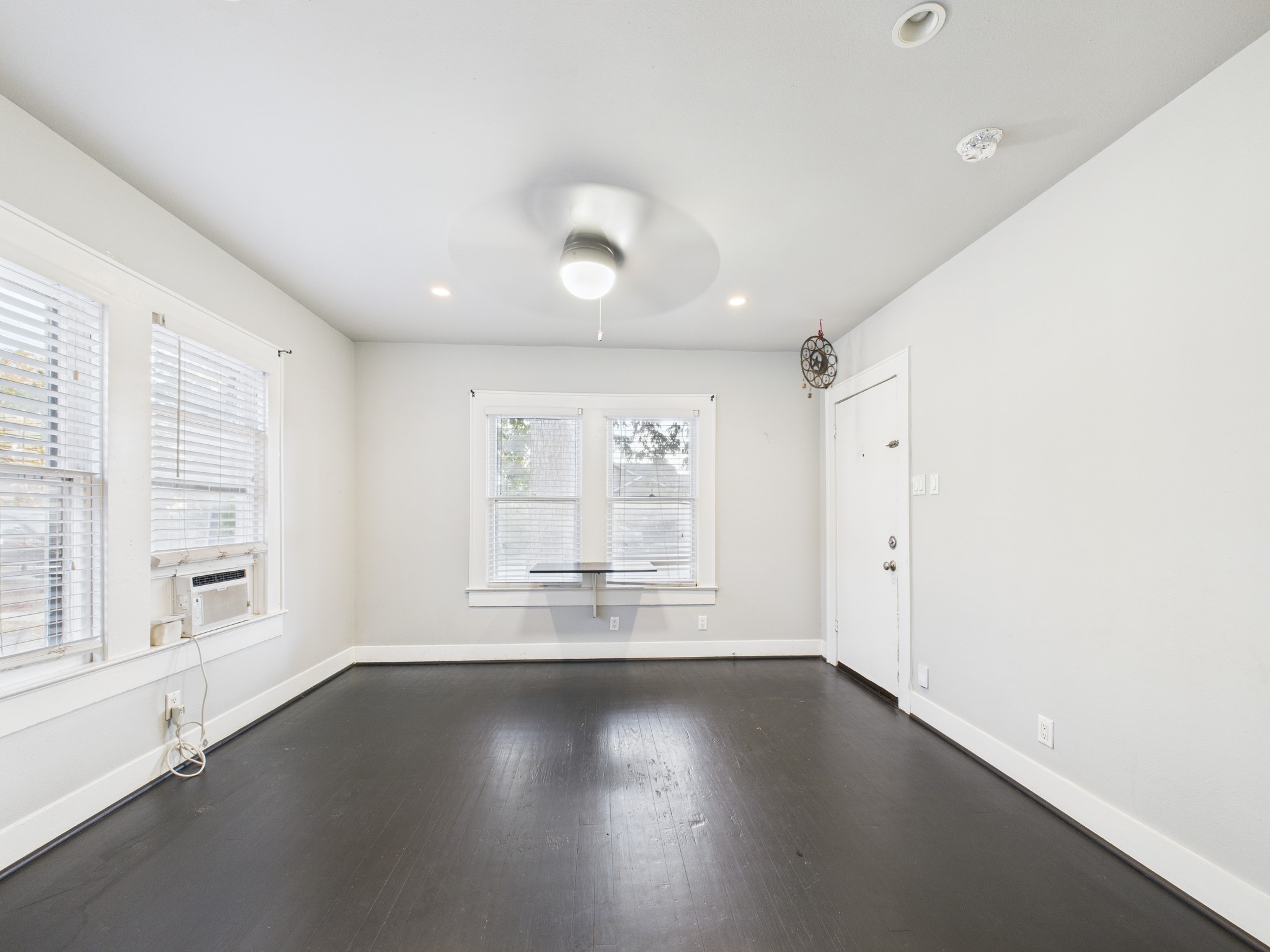 605 Enid Street, Unit 1 Houston, TX 77009 - Photo 7 of 9 an empty room with wooden floor and windows
