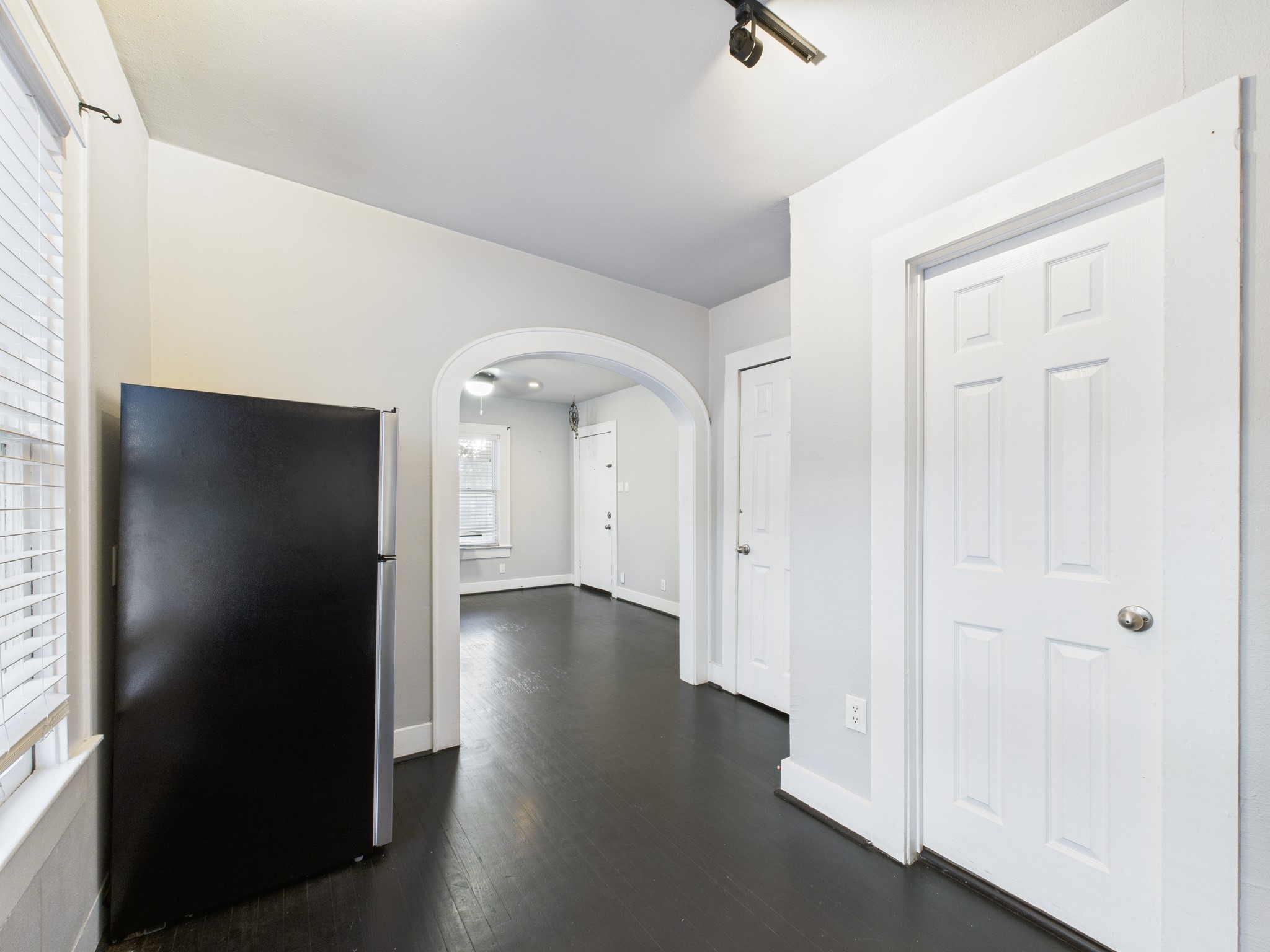 605 Enid Street, Unit 1 Houston, TX 77009 - Photo 8 of 9 an empty room with wooden floor and windows