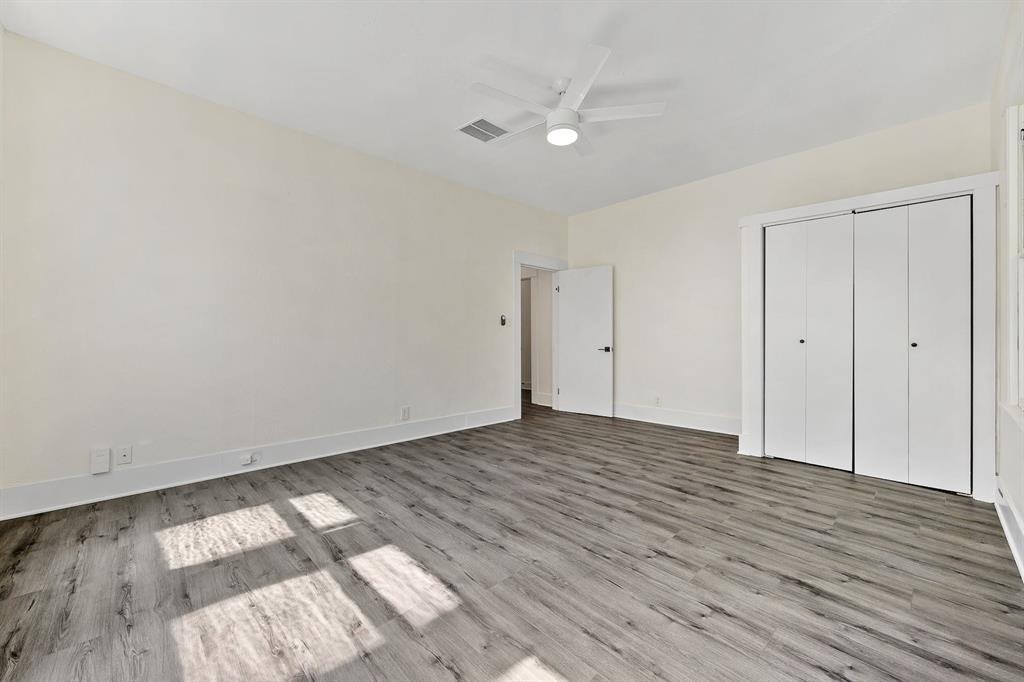 610 West 35th Street, Unit B Austin, TX 78705 - Photo 13 of 23 Unfurnished bedroom featuring light wood-style floors, ceiling fan, and a closet