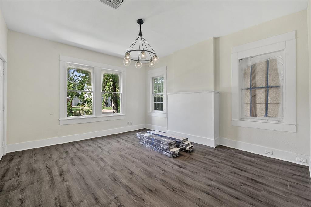 610 West 35th Street, Unit B Austin, TX 78705 - Photo 3 of 23 Unfurnished dining area featuring a chandelier and dark wood-style floors