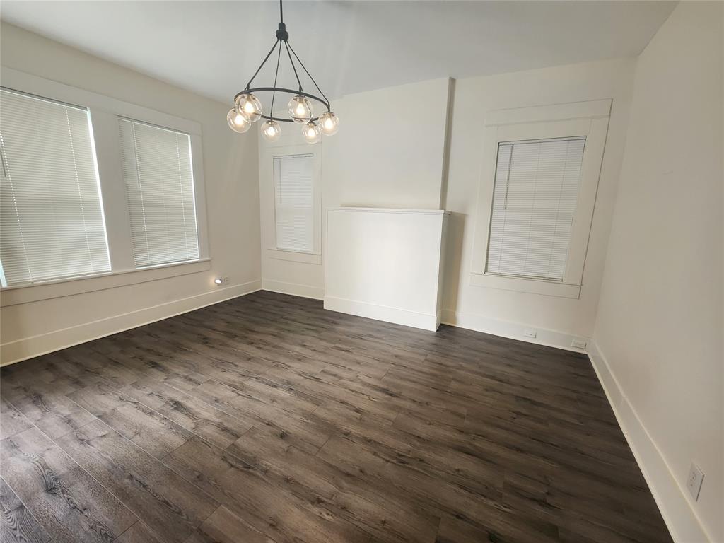 610 West 35th Street, Unit B Austin, TX 78705 - Photo 4 of 23 Unfurnished dining area featuring a chandelier and dark wood-style floors