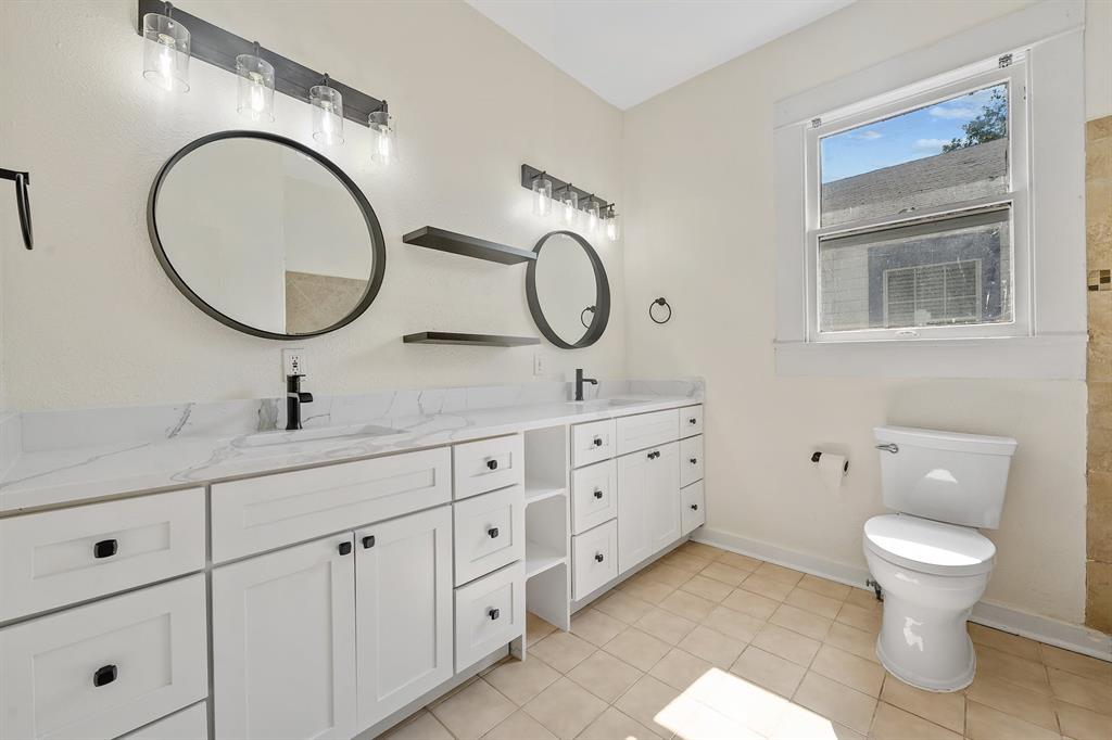 610 West 35th Street, Unit B Austin, TX 78705 - Photo 10 of 23 Full bathroom featuring double vanity and light tile patterned flooring