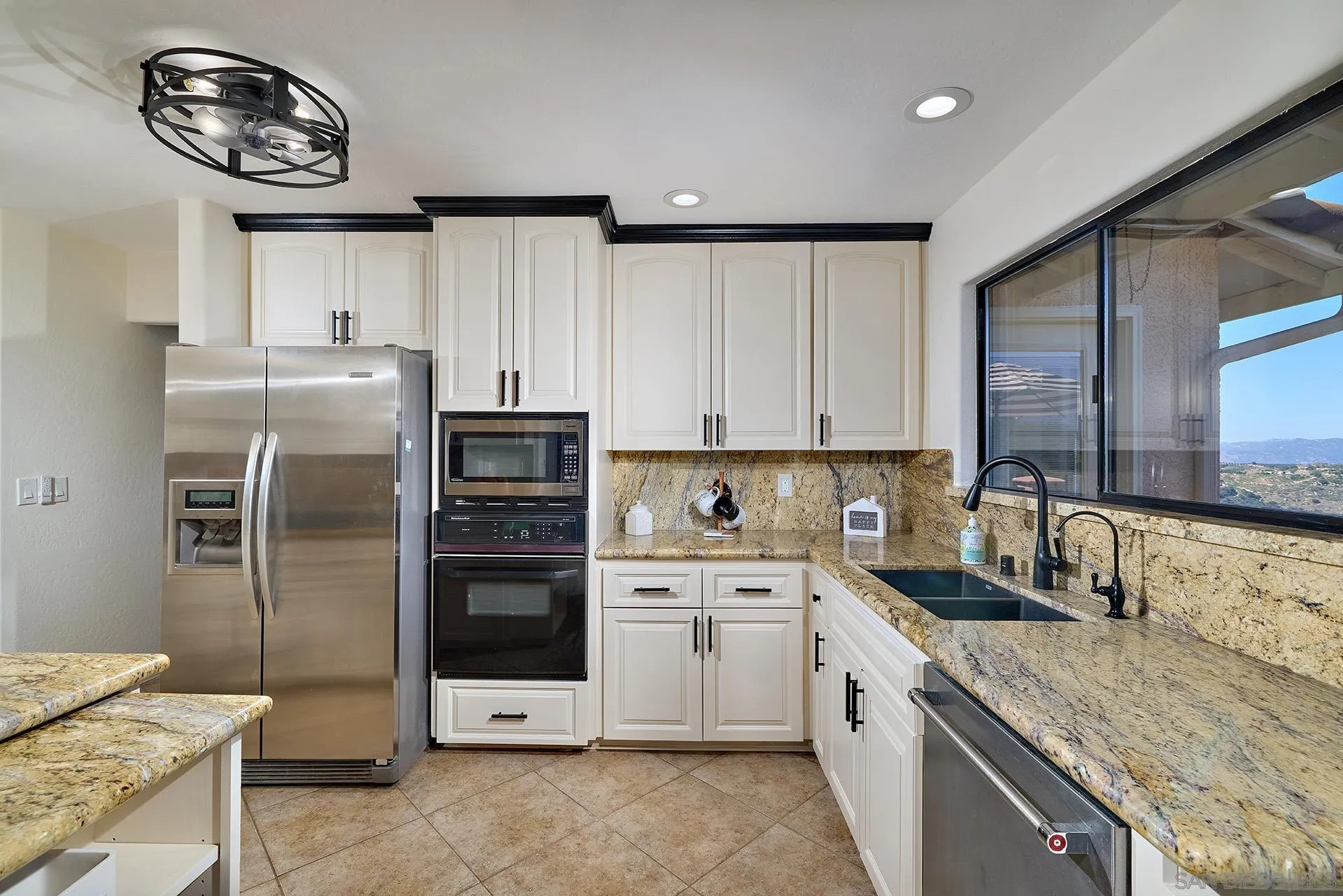 13588 McNally Road Valley Center, CA 92082 - Photo 14 of 43 a kitchen with a sink cabinets and stainless steel appliances