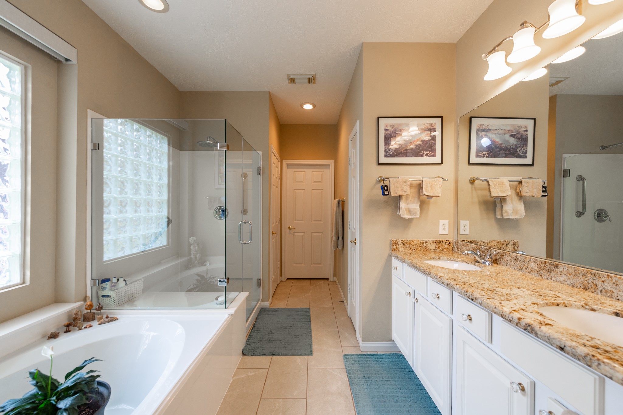 5230 Sandyfields Lane Katy, TX 77494 - Photo 17 of 24 Primary bathroom with double sinks, granite countertops, soaking tub, and glass-enclosed shower.