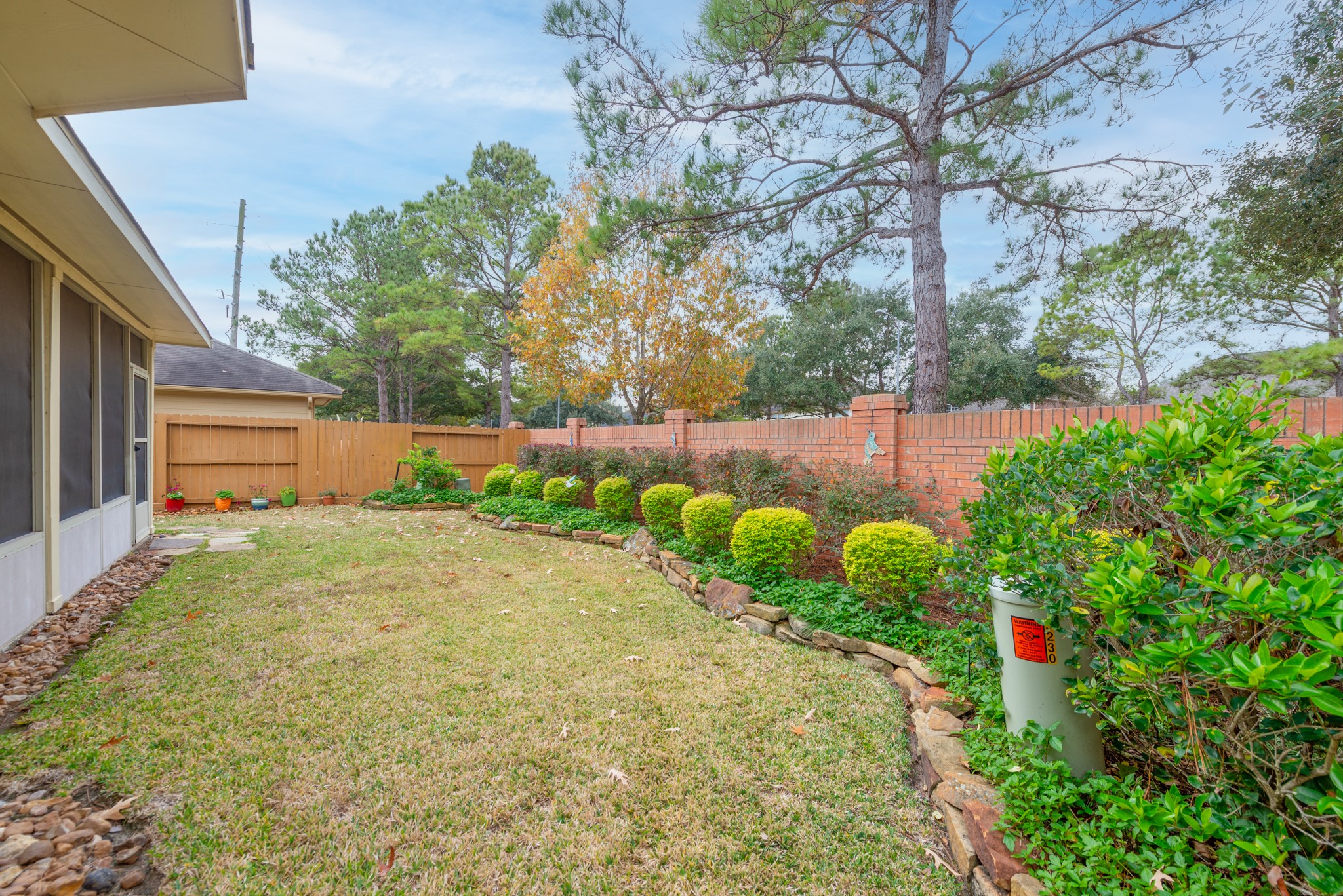 5230 Sandyfields Lane Katy, TX 77494 - Photo 22 of 24 Backyard area with wood privacy fencing and brick perimeter wall along the rear boundary.