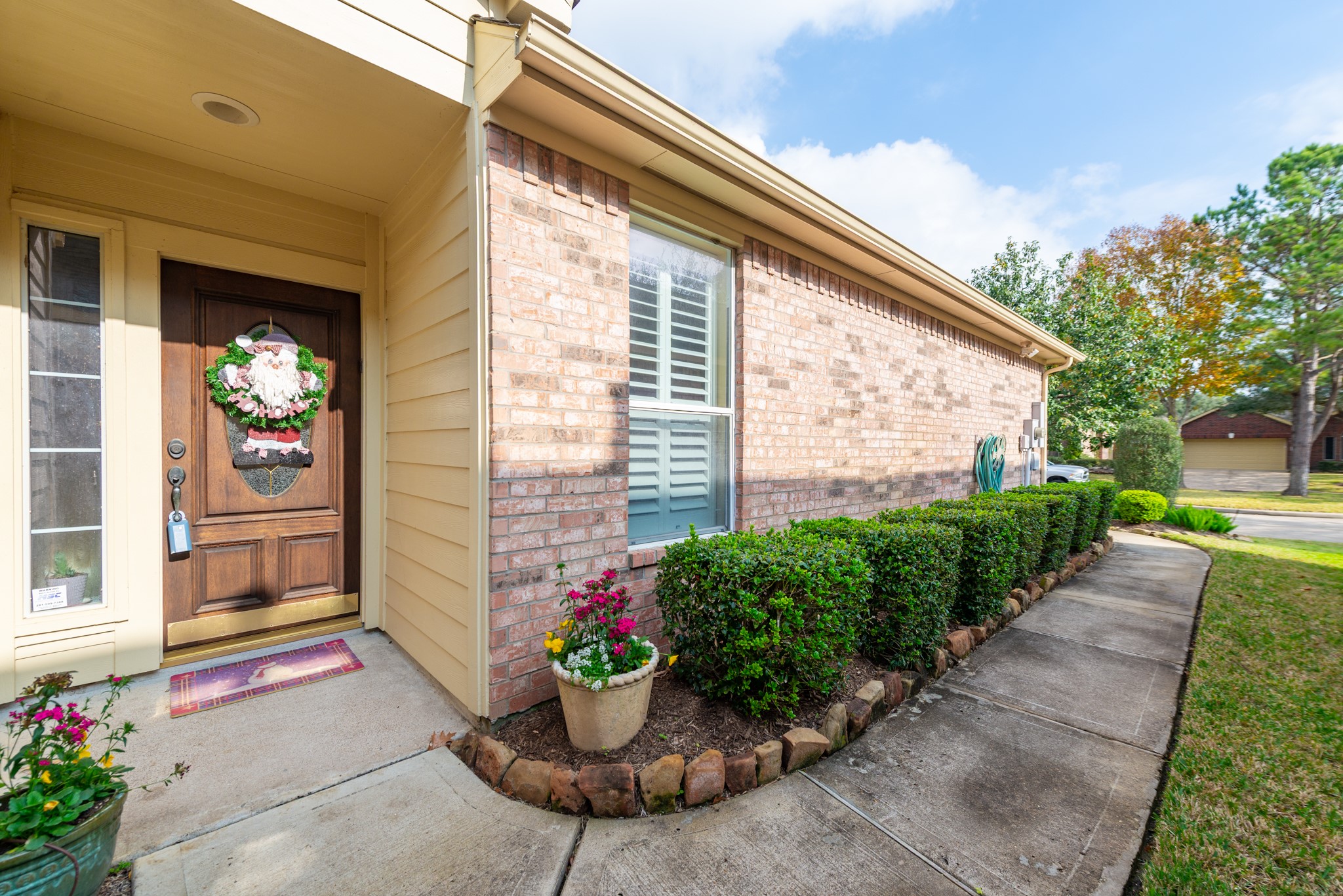 5230 Sandyfields Lane Katy, TX 77494 - Photo 4 of 24 Welcoming covered front porch and clean, well-kept walkway framed by lush greenery, setting the tone for this thoughtfully cared-for home.