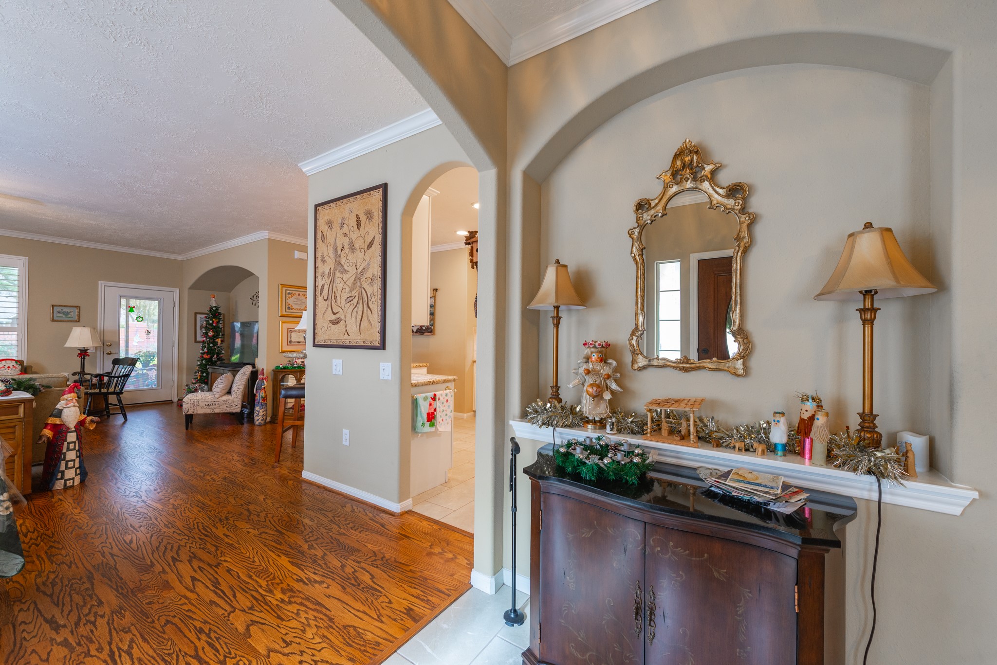 5230 Sandyfields Lane Katy, TX 77494 - Photo 5 of 24 Elegant entry with arched openings, crown molding, and tile flooring, offering a warm and inviting first impression.