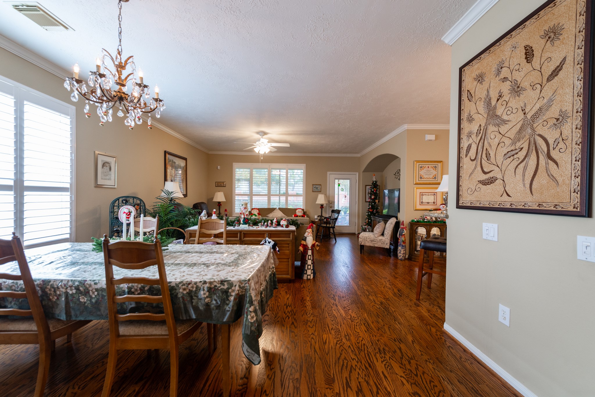 5230 Sandyfields Lane Katy, TX 77494 - Photo 8 of 24 Formal dining area with hardwood floors and chandelier lighting, perfect for hosting gatherings or everyday dining.