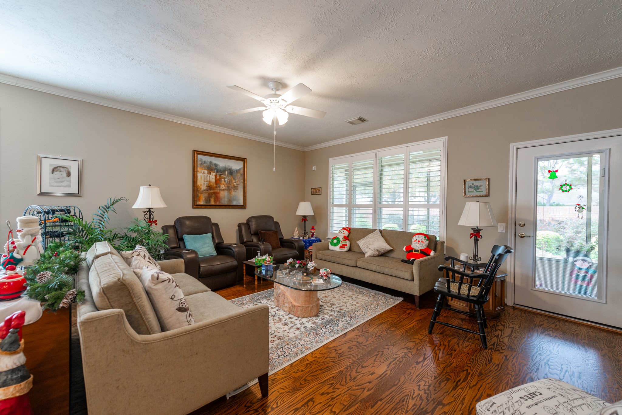 5230 Sandyfields Lane Katy, TX 77494 - Photo 9 of 24 Bright and comfortable living room featuring hardwood floors, plantation shutters, and a spacious layout ideal for relaxing or entertaining.