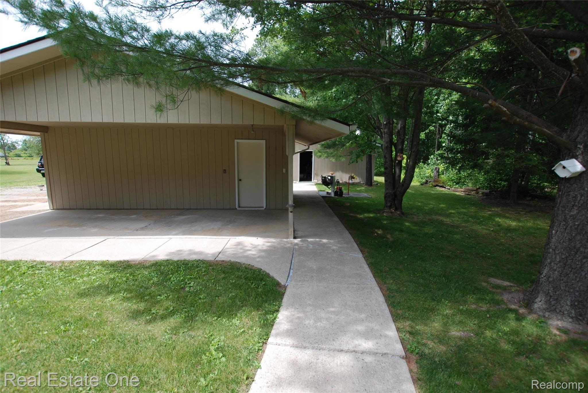 6185 Bricker Road Avoca, MI 48006 - Photo 5 of 32 Side of garage and carport with easy access walking path to storage barn from back of house