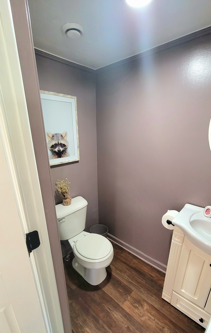 18 Manor Road Lake Zurich, IL 60047 - Photo 8 of 33 a white toilet sitting next to a bathroom sink and a mirror