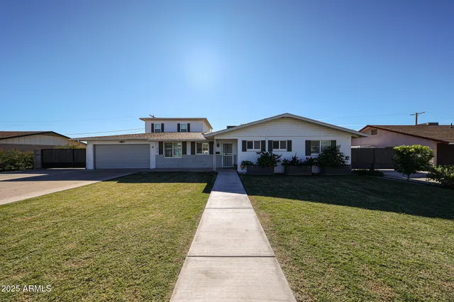 a front view of house with yard and car parked