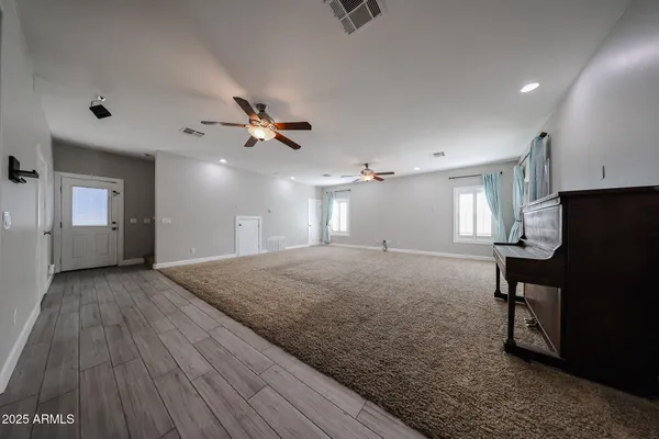 a view of a livingroom with a fireplace furniture and a ceiling fan