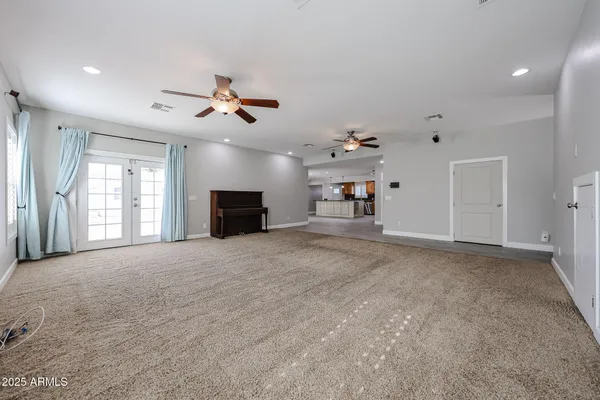 a view of a livingroom with furniture and a ceiling fan