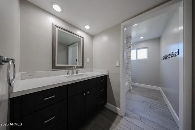 a bathroom with a double vanity sink and mirror
