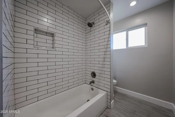 a bathroom with a bathtub and shower