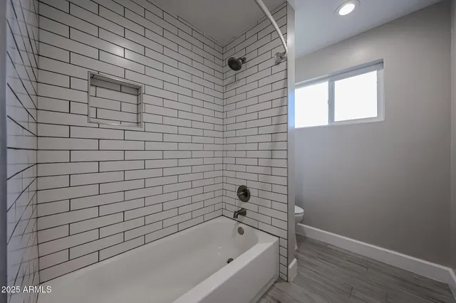 a bathroom with a bathtub and shower