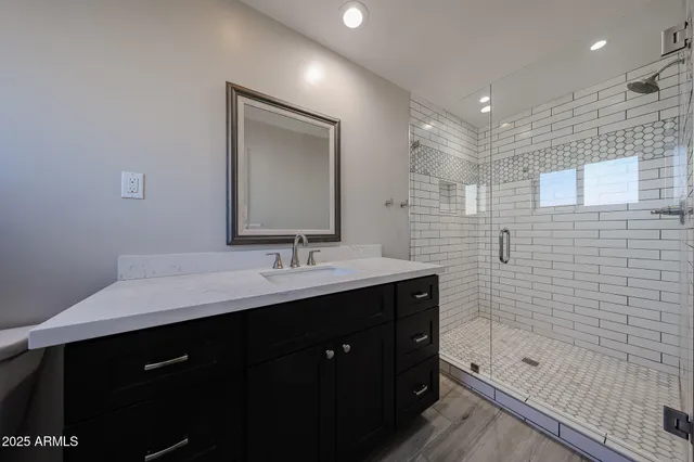 a bathroom with a bathtub shower sink double and mirror