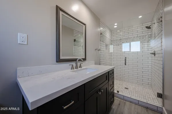 a bathroom with a sink a toilet and shower