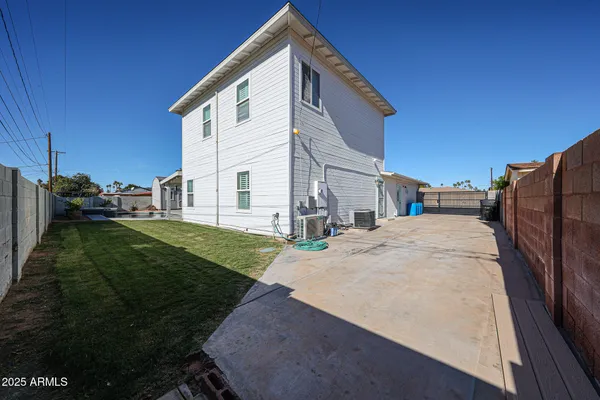 a view of backyard of house and trees