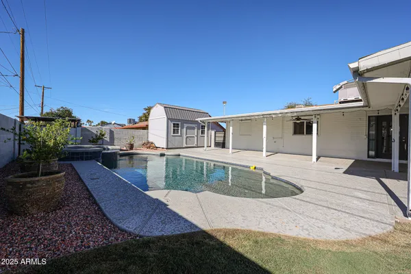 a view of a house with backyard and sitting area