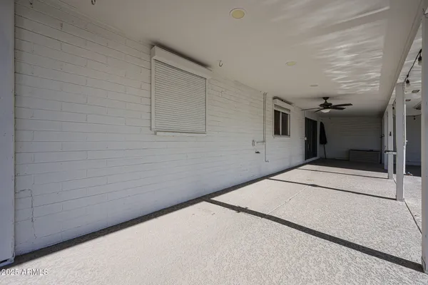 a view of a patio with couches and potted plants