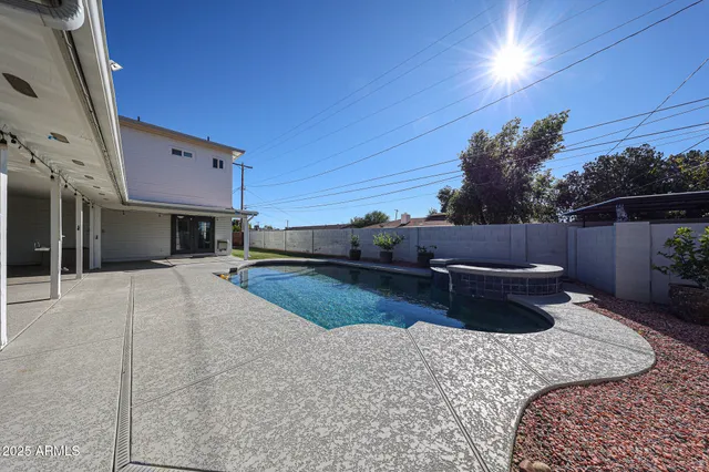 a view of a backyard with plants and a patio