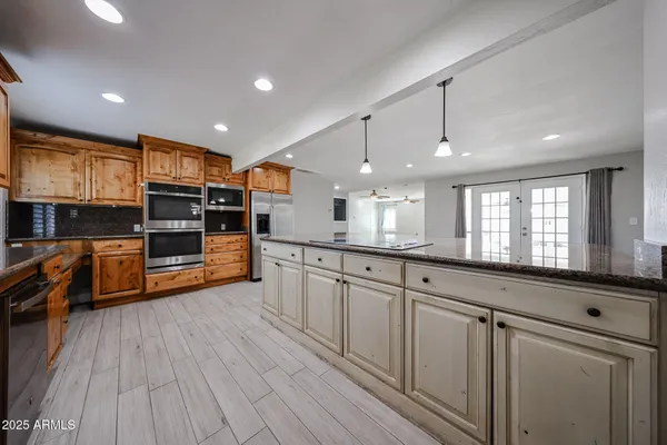 a large kitchen with stainless steel appliances and a large window
