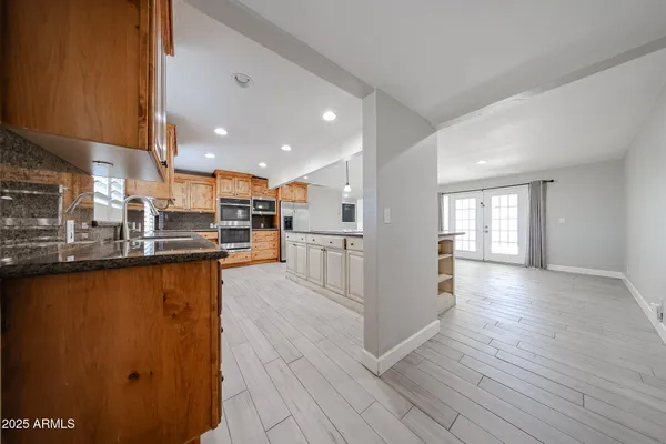 a view of kitchen with cabinets and wooden floor
