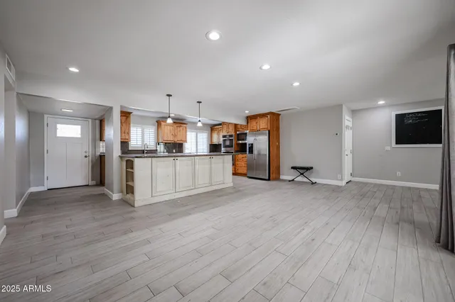a view of a kitchen with a sink and a refrigerator