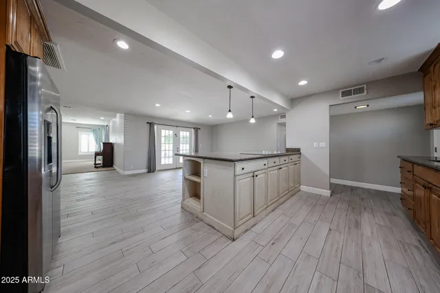 a view of kitchen with refrigerator microwave and wooden floor
