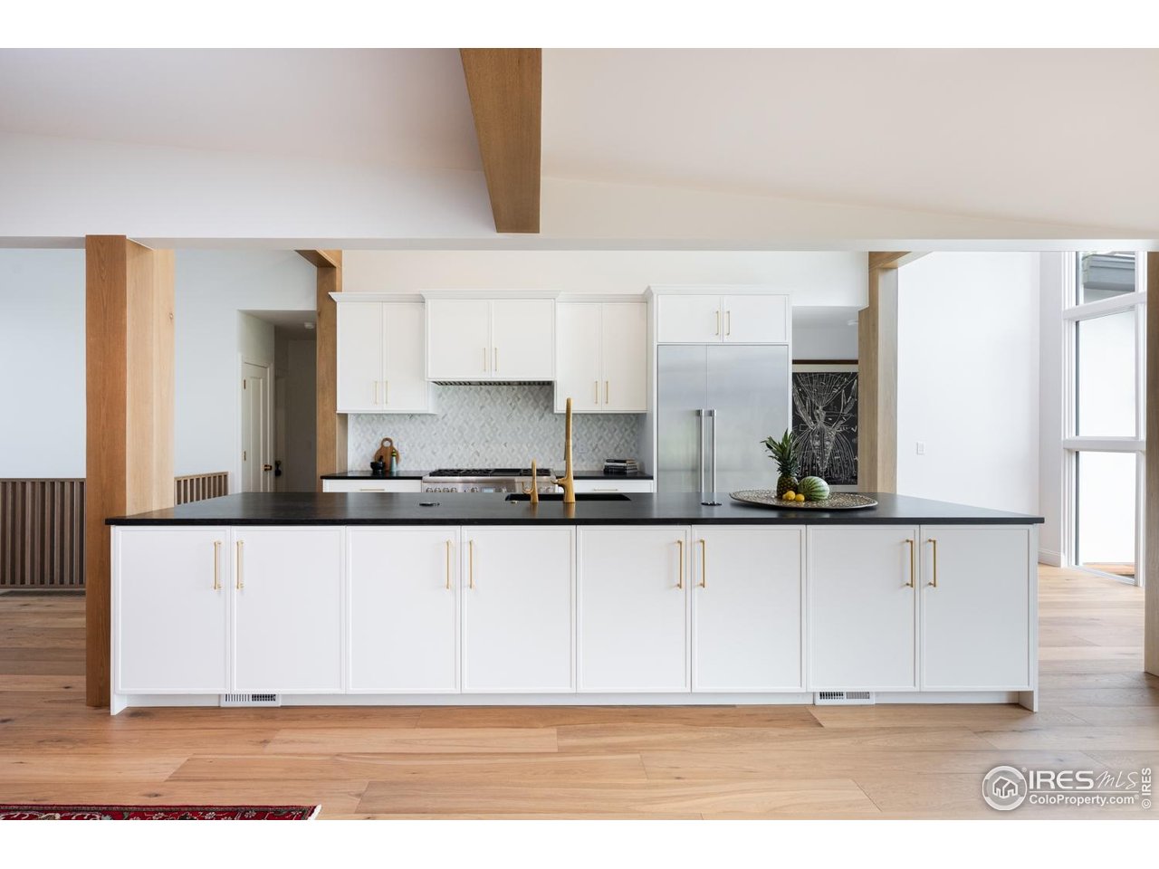 1450 High Street Boulder, CO 80304 - Photo 12 of 50 a white kitchen with granite countertop a sink a stove and a wooden floors