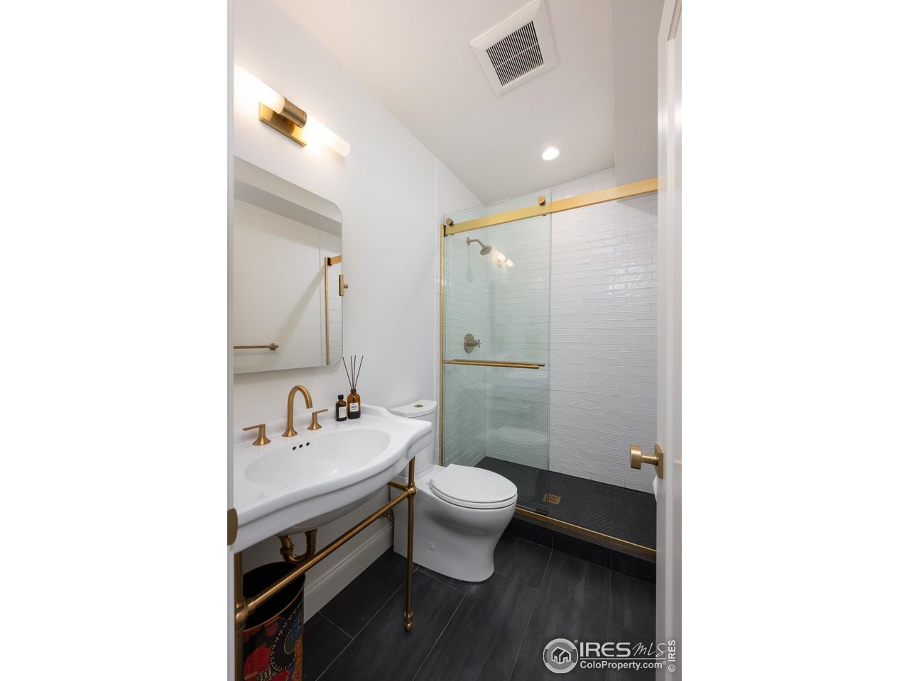 1450 High Street Boulder, CO 80304 - Photo 36 of 50 a bathroom with a sink a toilet and a mirror