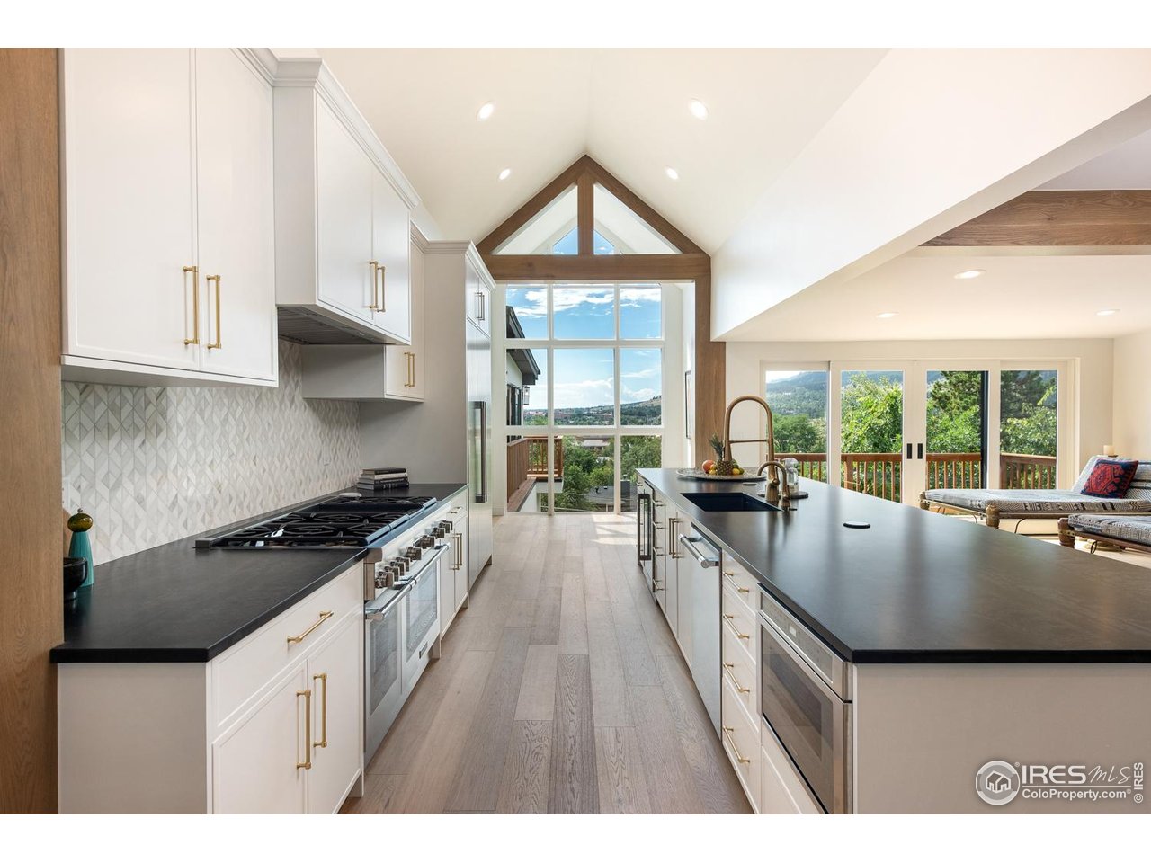 1450 High Street Boulder, CO 80304 - Photo 10 of 50 a kitchen with granite countertop a stove a sink a refrigerator and white cabinets with wooden floor