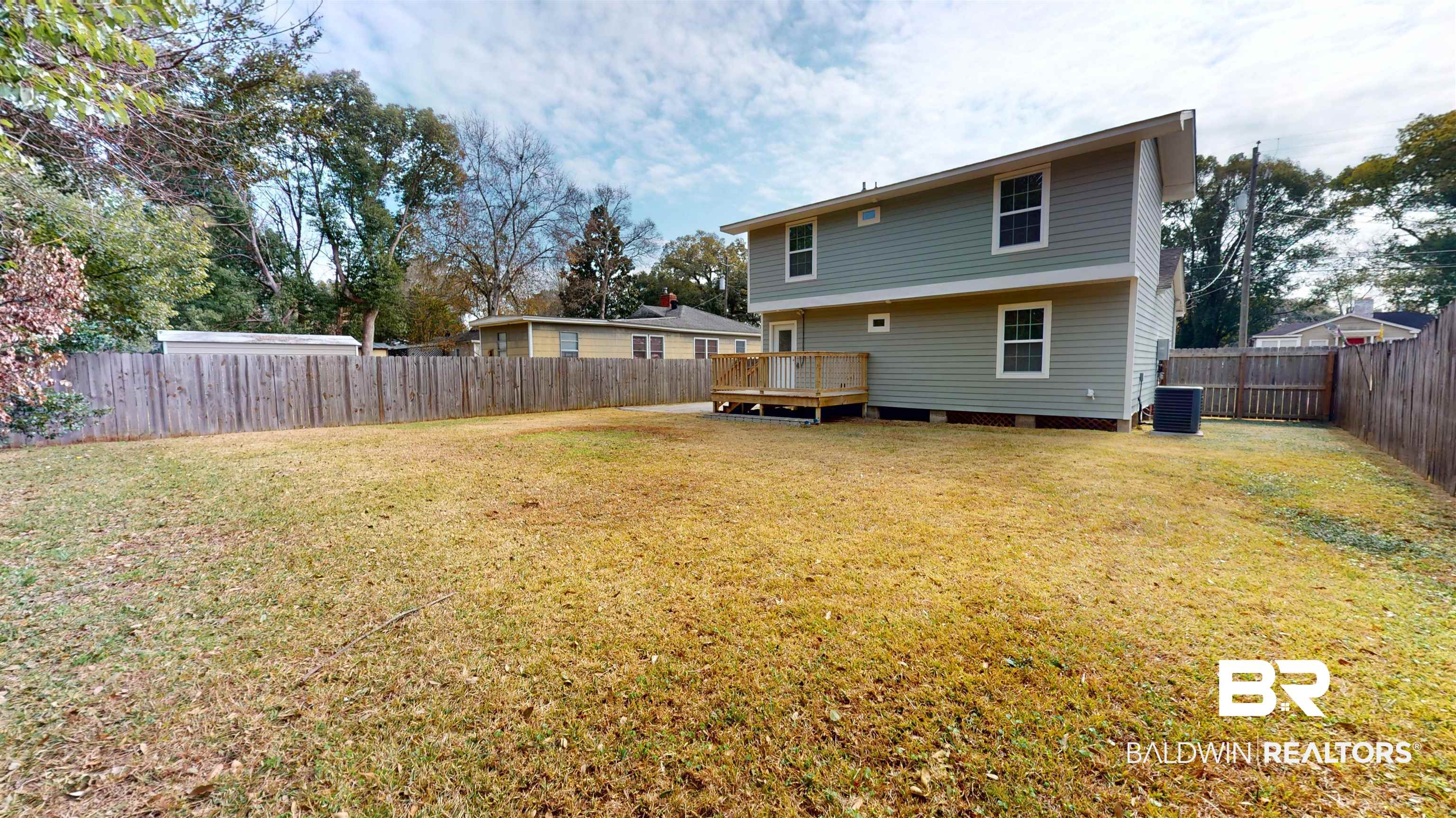 2454 Taylor Avenue Mobile, AL 36606 - Photo 4 of 24 Rear view of house with a wooden deck and a fenced backyard