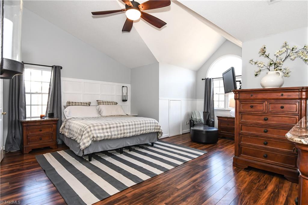 6401 High View Road Greensboro, NC 27410 - Photo 14 of 28 Great sized master suite with sitting area, ceiling fan, laminate hardwood flooring and vaulted ceilings! Giant closet can be accessed directly from the bedroom or from the en-suite bathroom. Eave storage in the bedroom and in the master closet!