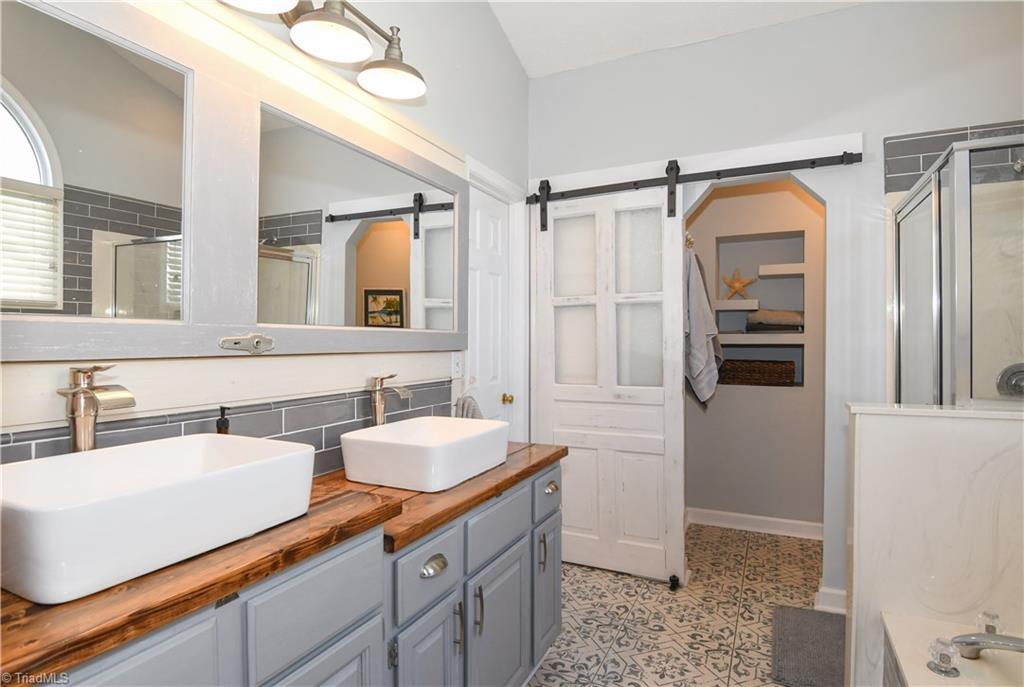6401 High View Road Greensboro, NC 27410 - Photo 15 of 28 Master bath renovation completed December '17! Check out the beautiful tile flooring, updated dual vanities, subway tile back splash, mirror & updated lighting!