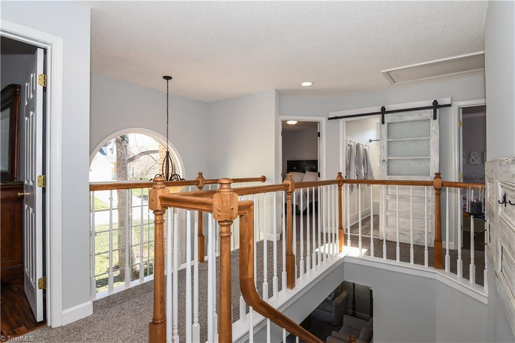 6401 High View Road Greensboro, NC 27410 - Photo 17 of 28 Upstairs landing features brand new carpet and overlooks the entry way!