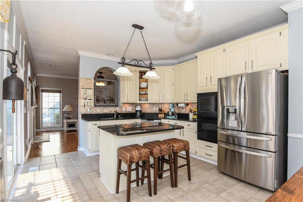 6401 High View Road Greensboro, NC 27410 - Photo 8 of 28 The kitchen also features a stainless refrigerator and dishwasher, granite counters, tile back splash & crown molding!