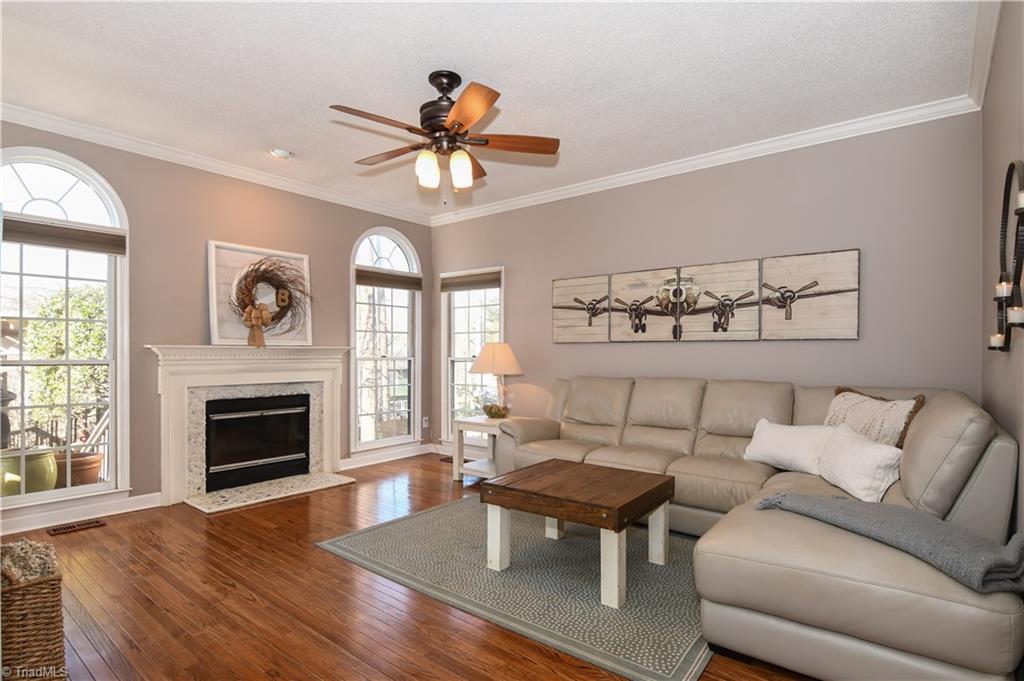6401 High View Road Greensboro, NC 27410 - Photo 10 of 28 Den features hardwood floors & a wood burning fireplace with a river stone hearth!