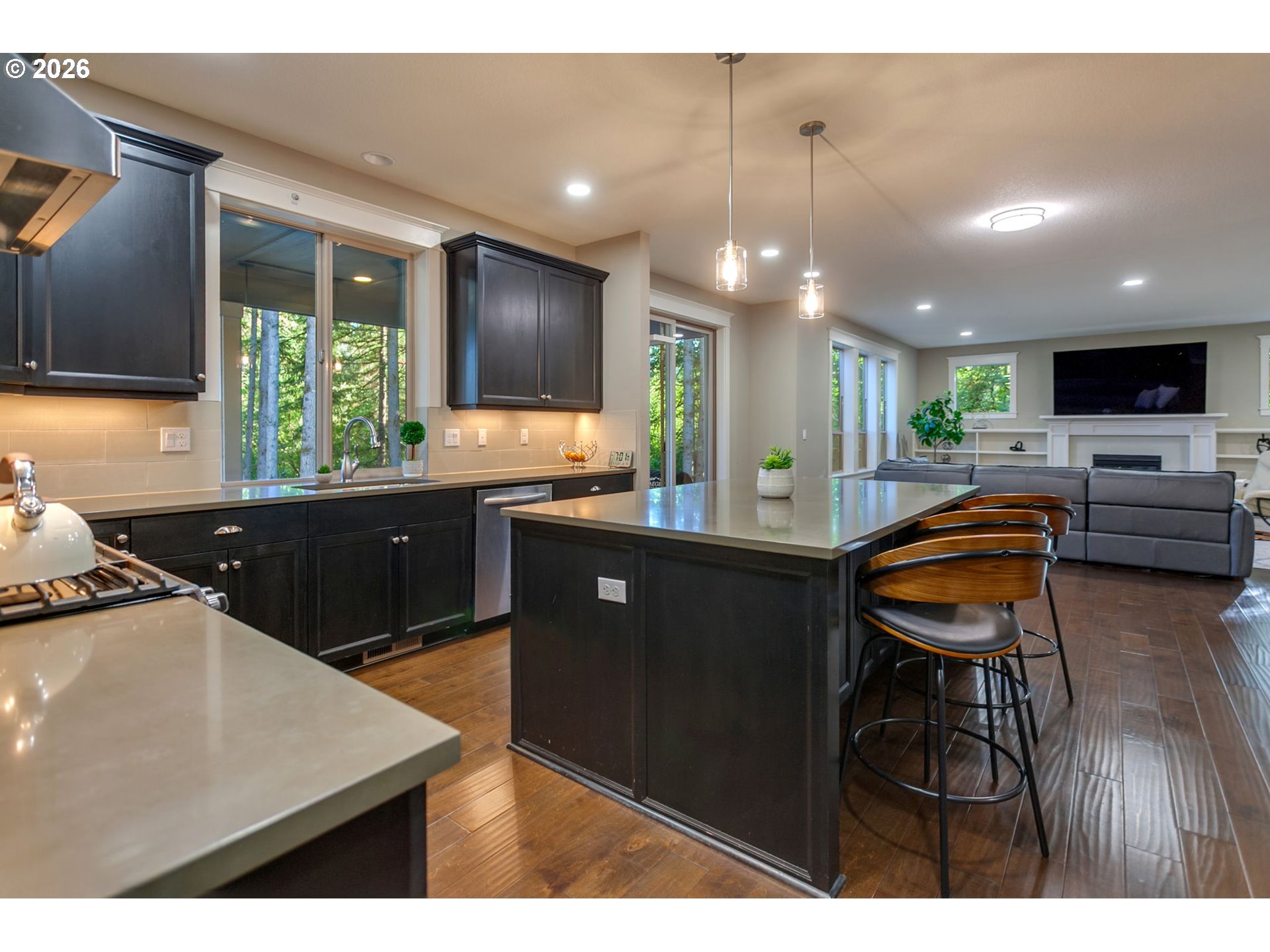 14390 Southwest Fox Lane Beaverton, OR 97008 - Photo 14 of 47 a kitchen with stainless steel appliances kitchen island granite countertop a sink counter space and a view of living room