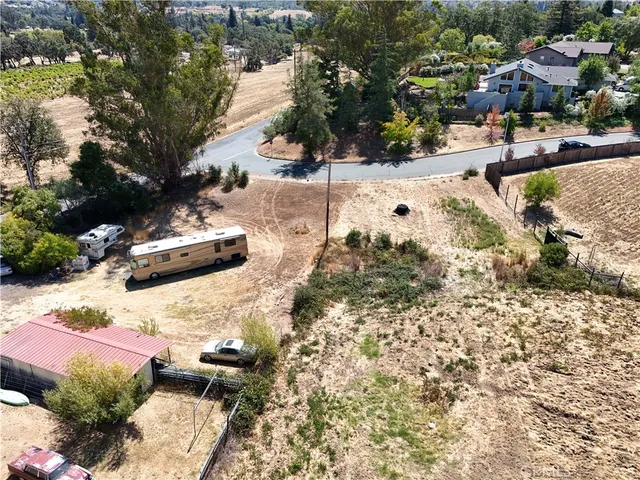 a view of a yard with wooden fence