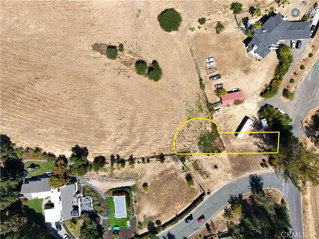 an aerial view of a house with a yard covered in the background