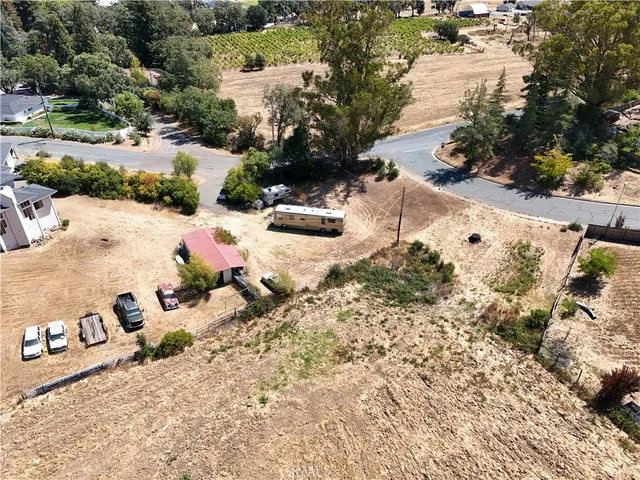 an aerial view of a house with a yard and lake view